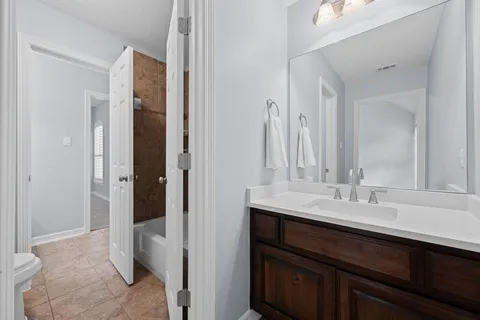 a en suite bathroom with a sink and a mirror