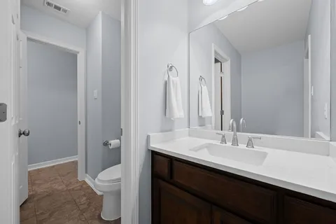a bathroom with a sink a toilet a shower and a mirror
