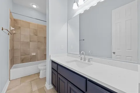 a view of a backyard with large trees and a wooden fence