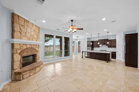 a large white kitchen with a sink outdoor seating and stainless steel appliances