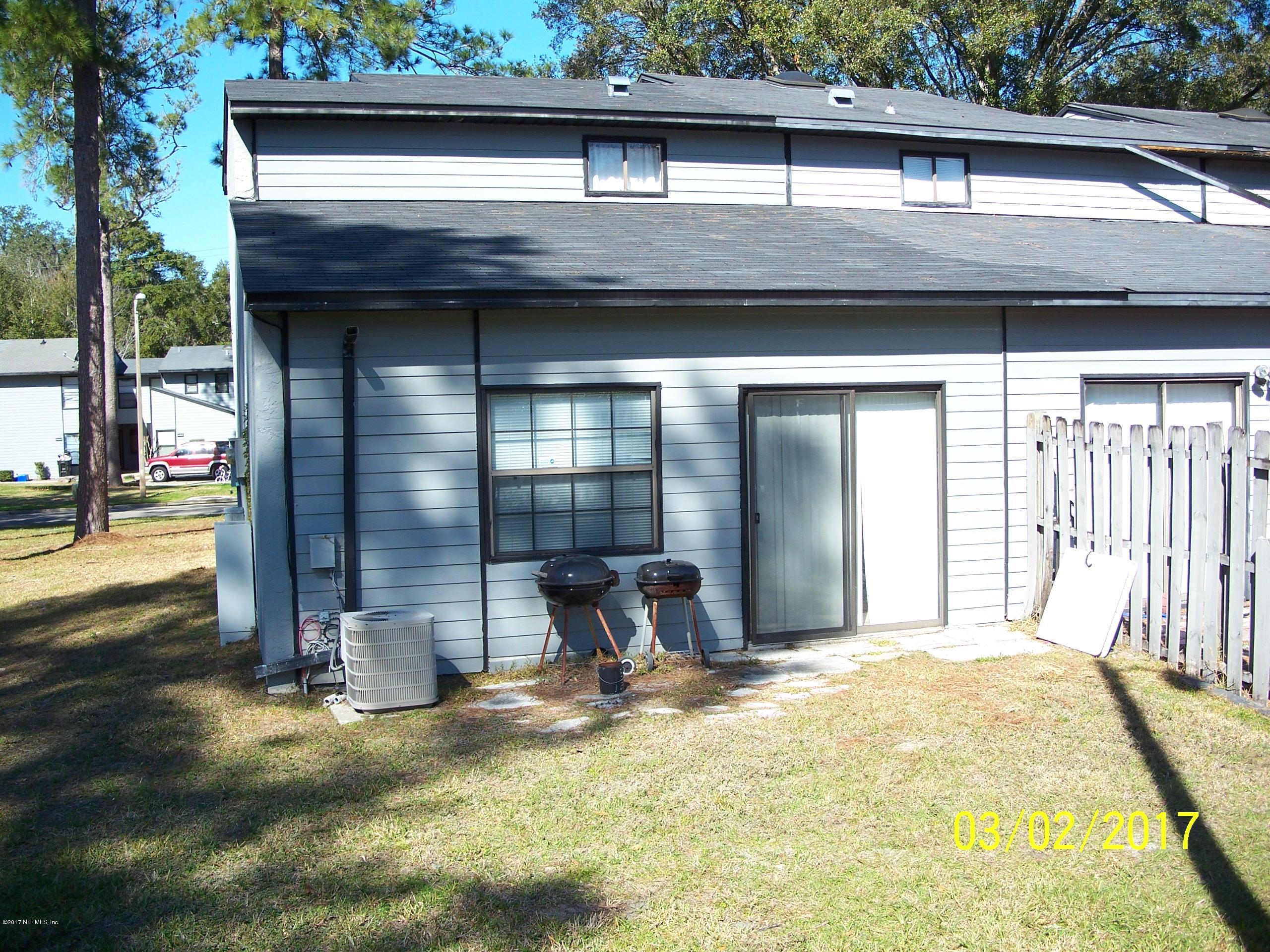 4429 Southwest 20th Lane Gainesville, FL 32607 - Photo 2 of 12 a view of a house with a patio and a yard
