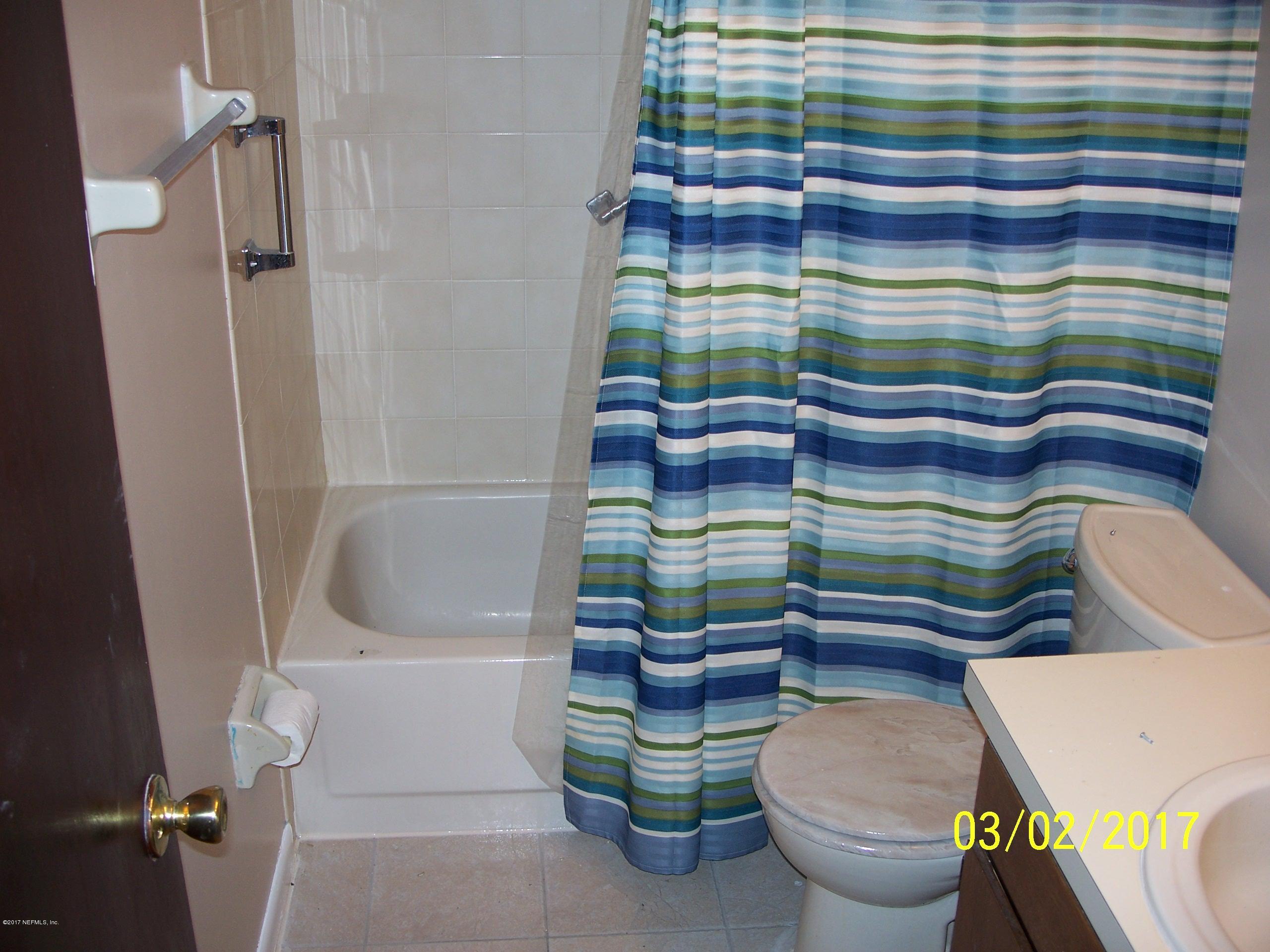 4429 Southwest 20th Lane Gainesville, FL 32607 - Photo 9 of 12 a bathroom with a sink toilet and shower