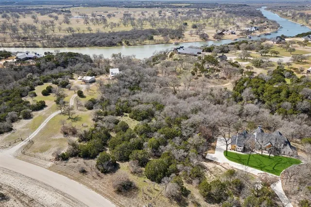 a view of a dry yard with green space