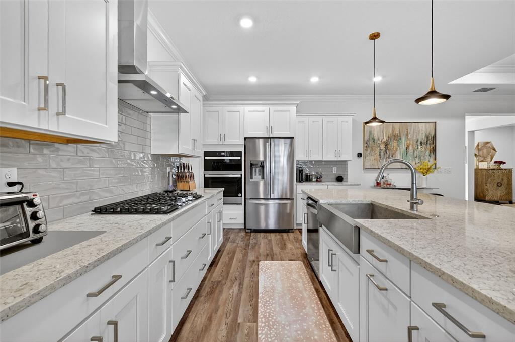 8433 Southwest 98th Terrace Road Ocala, FL 34481 - Photo 12 of 30 a large kitchen with stainless steel appliances granite countertop a sink stove and refrigerator