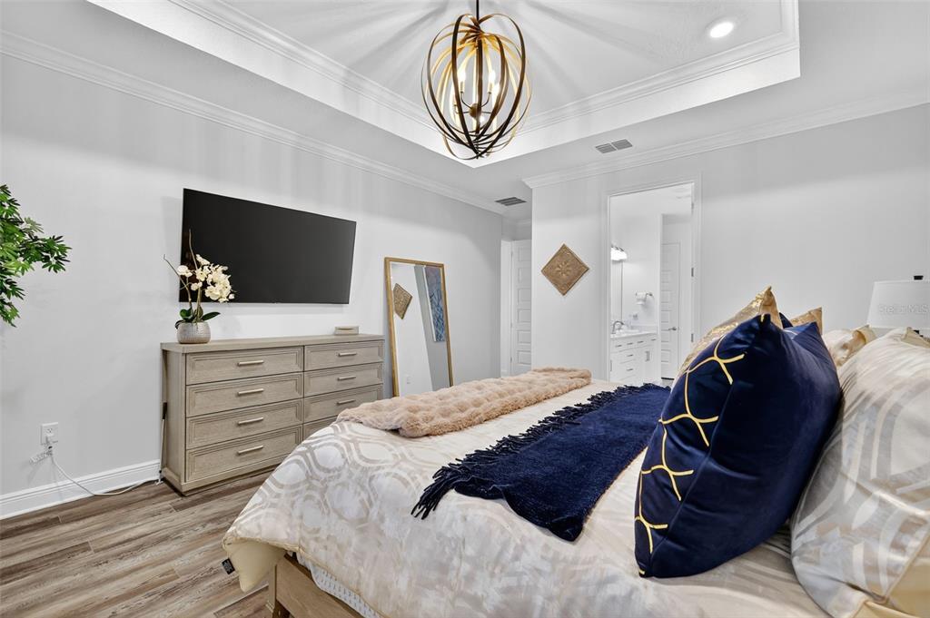 8433 Southwest 98th Terrace Road Ocala, FL 34481 - Photo 17 of 30 a bedroom with a bed and a flat screen tv