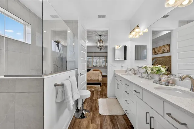 a bathroom with a granite countertop sink mirror vanity and toilet
