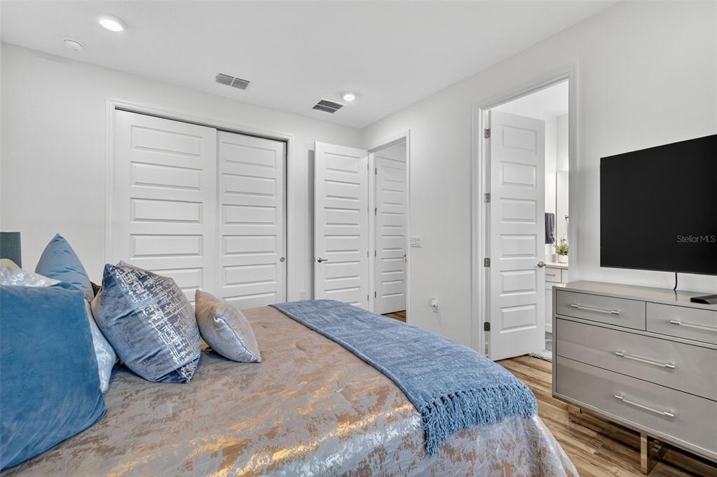 8433 Southwest 98th Terrace Road Ocala, FL 34481 - Photo 26 of 30 a bedroom with a bed and a flat screen tv in a bedroom