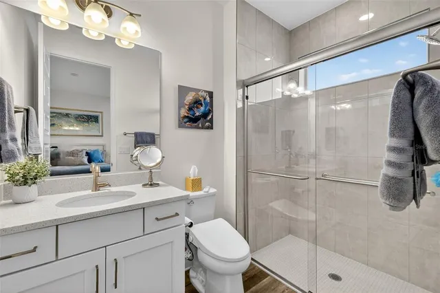 a bathroom with a sink toilet and shower