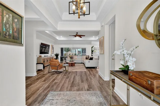 a living room with furniture and a chandelier
