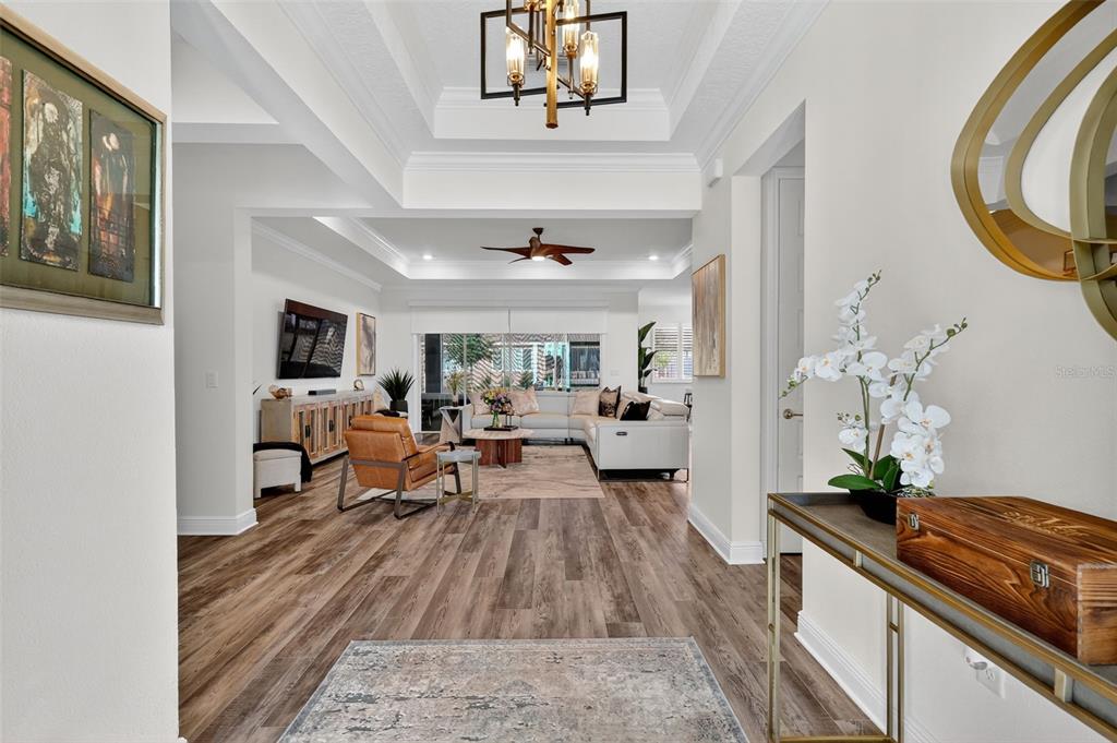 8433 Southwest 98th Terrace Road Ocala, FL 34481 - Photo 4 of 30 a living room with furniture and a chandelier