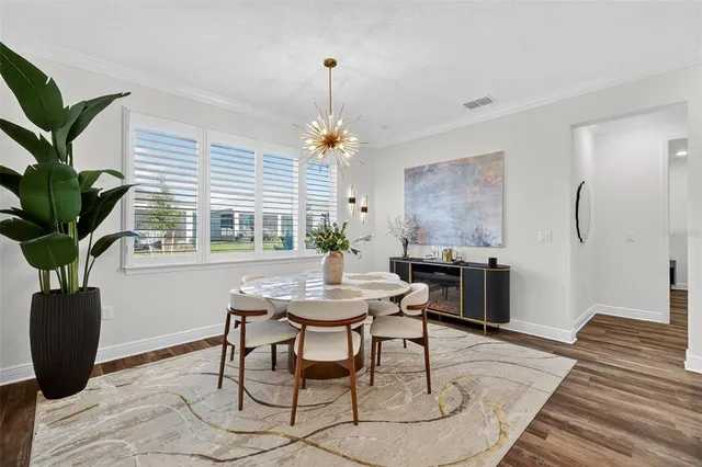 a view of a dining room with furniture window and wooden floor