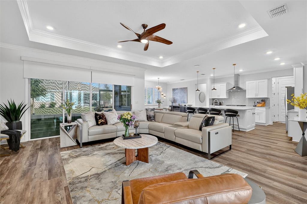 8433 Southwest 98th Terrace Road Ocala, FL 34481 - Photo 7 of 30 a living room with furniture kitchen view and a wooden floor