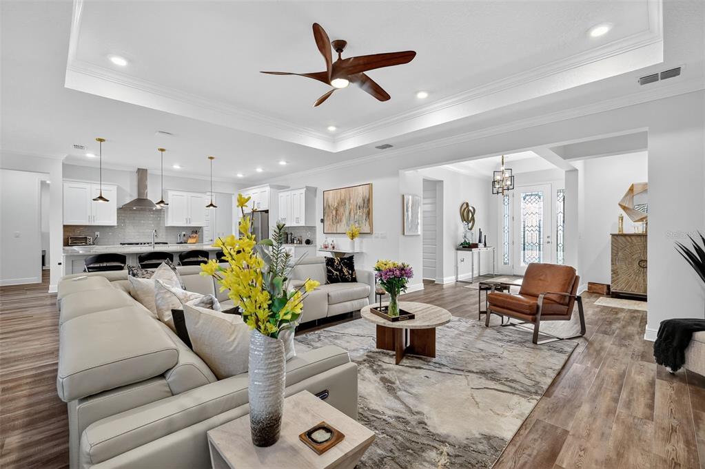 8433 Southwest 98th Terrace Road Ocala, FL 34481 - Photo 9 of 30 a living room with furniture kitchen view and a chandelier