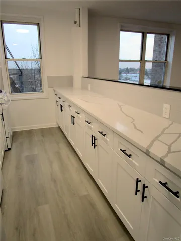 a kitchen with white cabinets and appliances