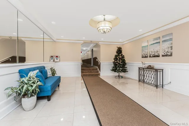 a hallway with a flower pot and a chandelier