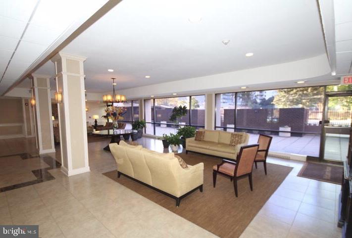 6800 Fleetwood Road, Unit 214 McLean, VA 22101 - Photo 20 of 22 a living room with furniture a rug and a view
