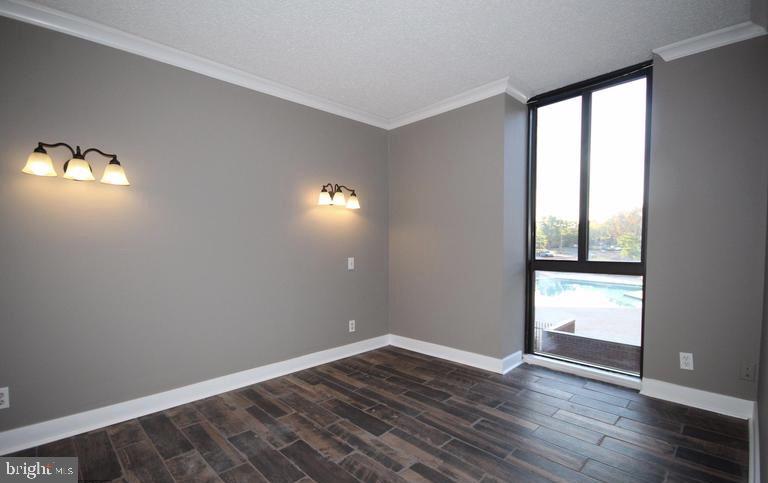 6800 Fleetwood Road, Unit 214 McLean, VA 22101 - Photo 8 of 22 wooden floor in an empty room with a window