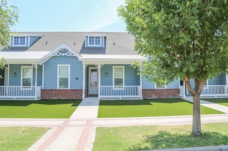 2114 10th Street Lubbock, TX 79401 - Photo 1 of 1 a view of a brick house with a big yard and large trees