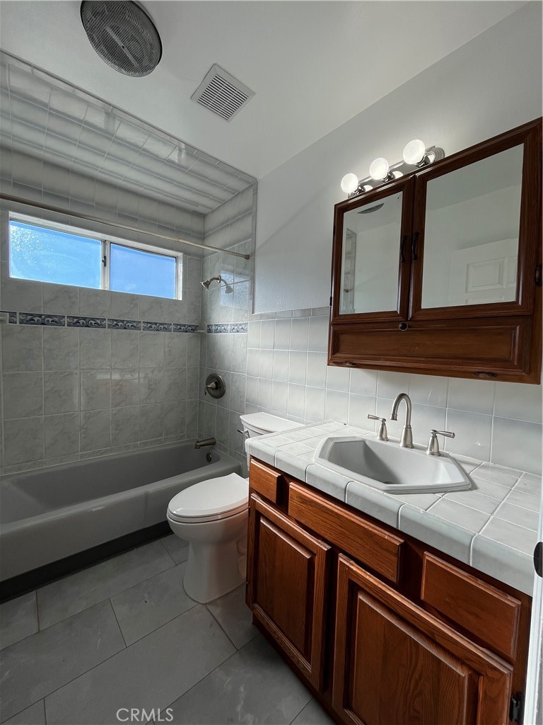7522 Balcom Avenue Reseda, CA 91335 - Photo 16 of 22 a bathroom with a toilet a sink and bathtub