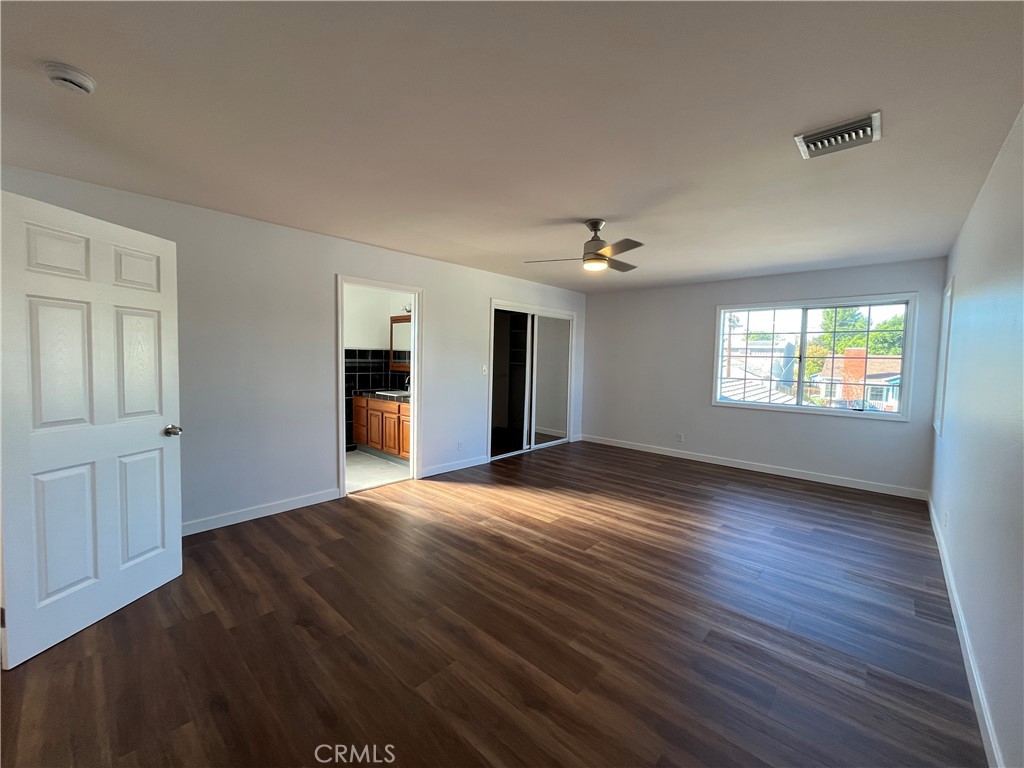 7522 Balcom Avenue Reseda, CA 91335 - Photo 18 of 22 a view of an empty room with window and wooden floor