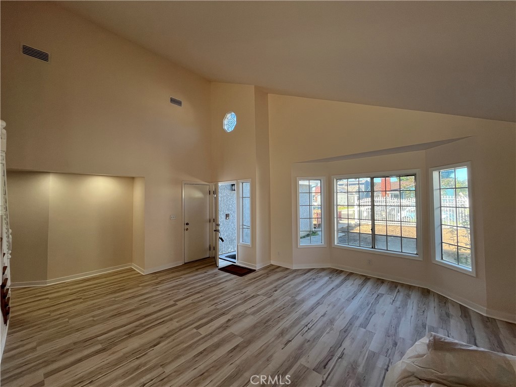 7522 Balcom Avenue Reseda, CA 91335 - Photo 3 of 22 an empty room with wooden floor and windows