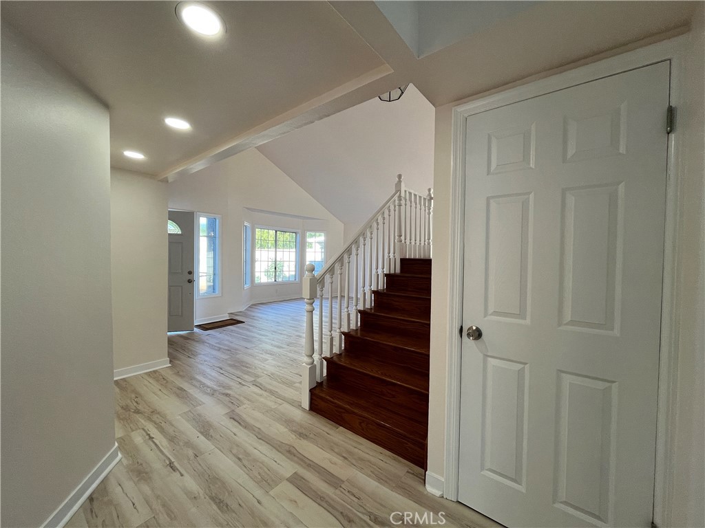 7522 Balcom Avenue Reseda, CA 91335 - Photo 5 of 22 a view of a hallway with wooden floor and entryway