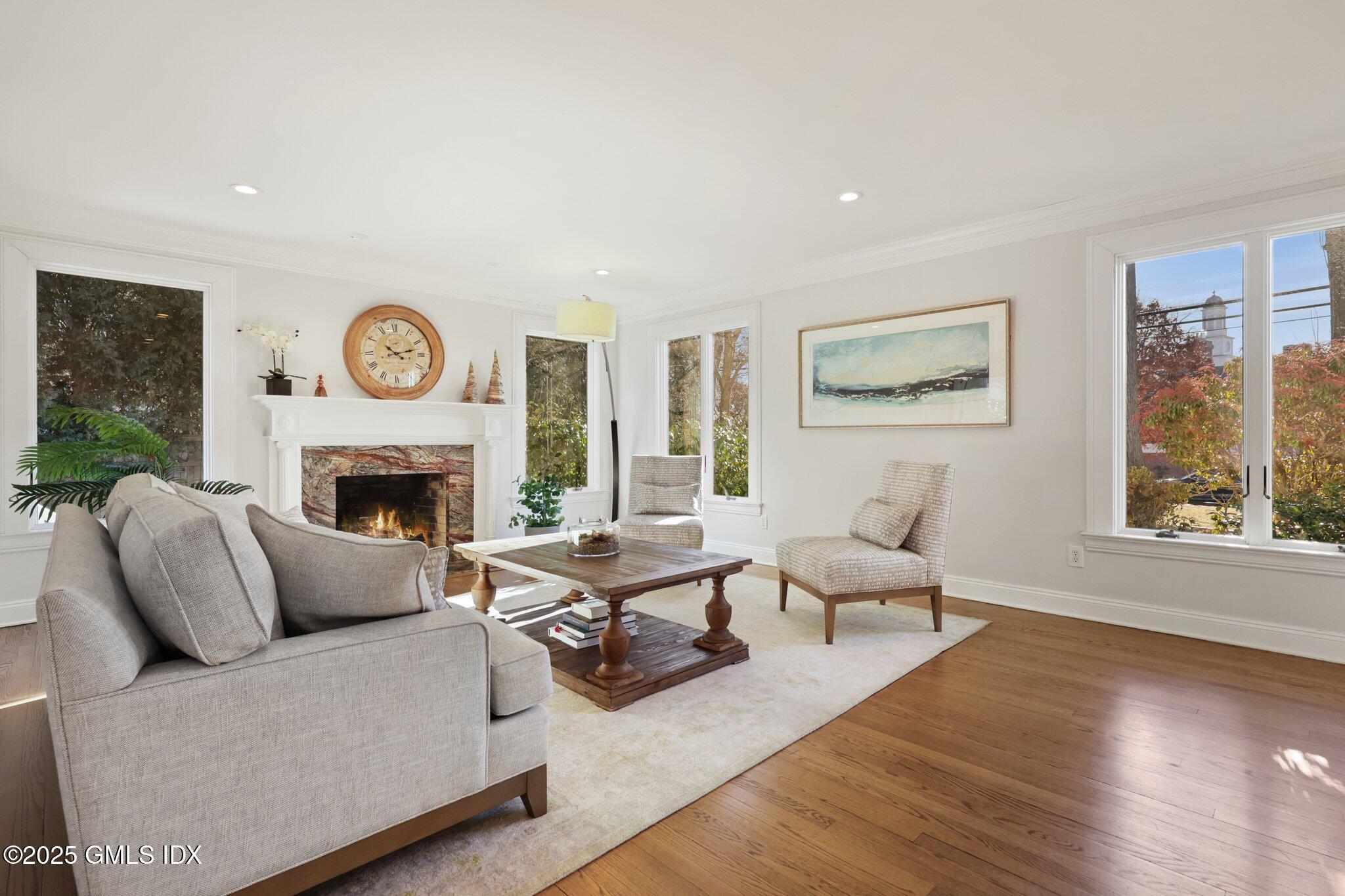 81 Hendrie Avenue Riverside, CT 06878 - Photo 11 of 35 a living room with furniture a clock and a fireplace