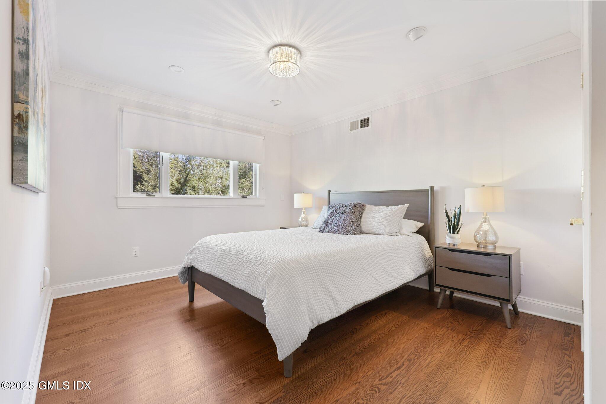 81 Hendrie Avenue Riverside, CT 06878 - Photo 16 of 35 a bedroom with a bed and a window