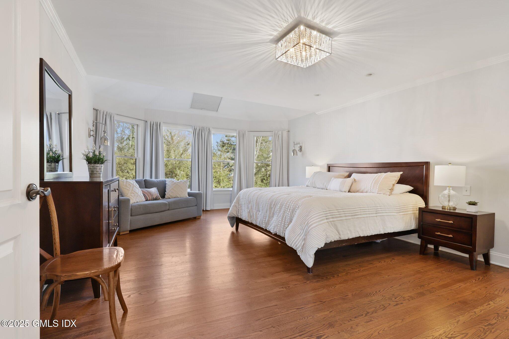 81 Hendrie Avenue Riverside, CT 06878 - Photo 19 of 35 a spacious bedroom with a bed and a couch