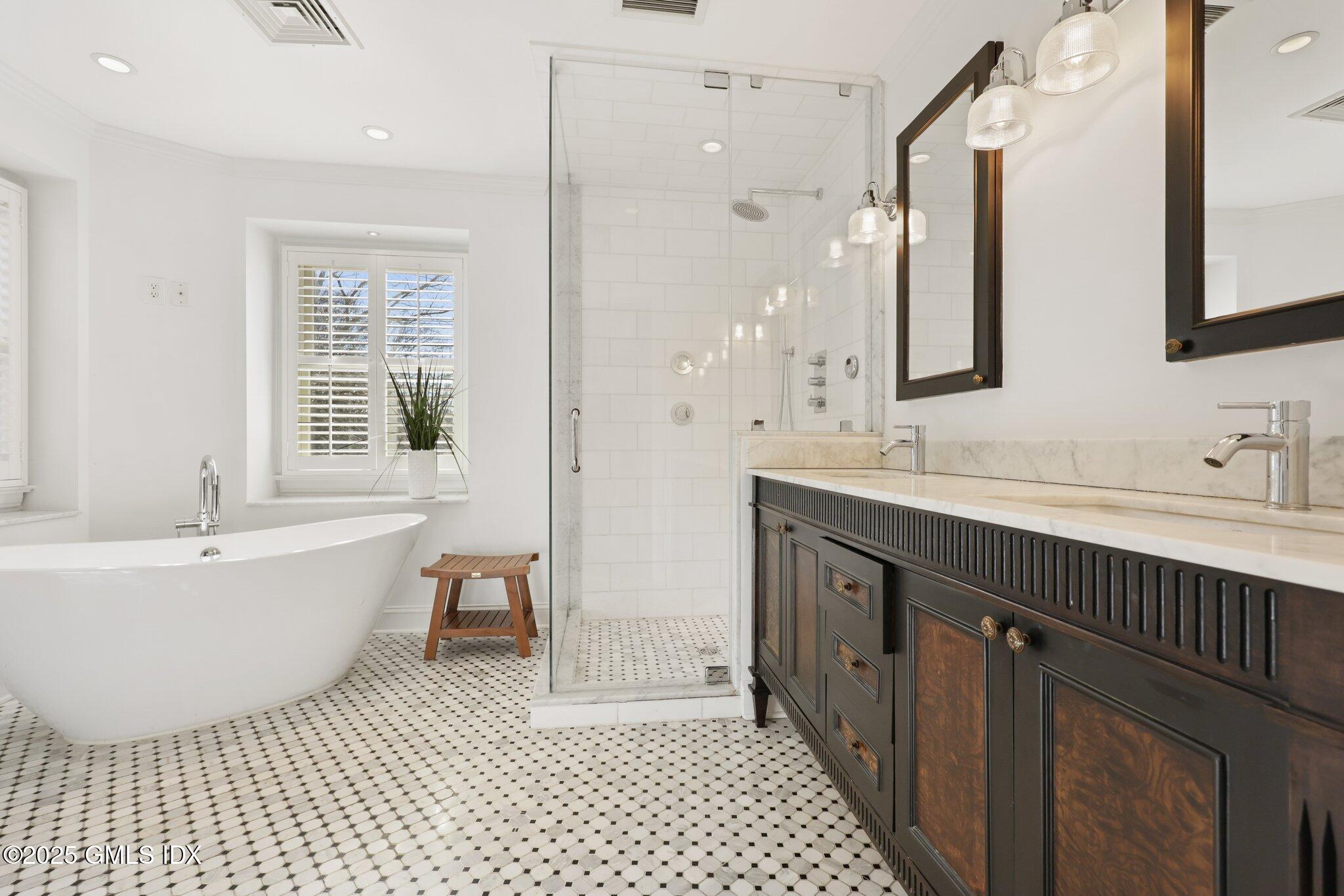 81 Hendrie Avenue Riverside, CT 06878 - Photo 20 of 35 a spacious bathroom with a double vanity sink a mirror and a bathtub