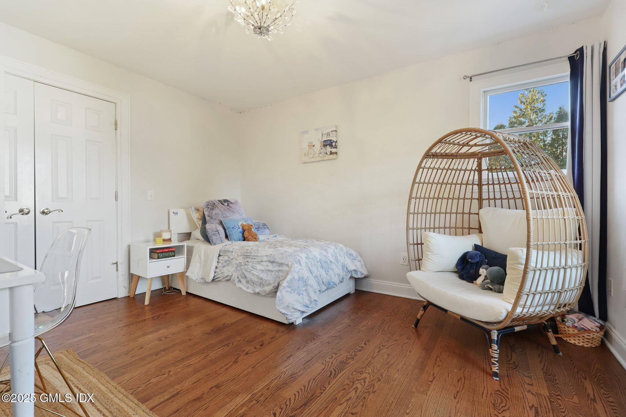 81 Hendrie Avenue Riverside, CT 06878 - Photo 21 of 35 a bedroom with a bed and wooden floor