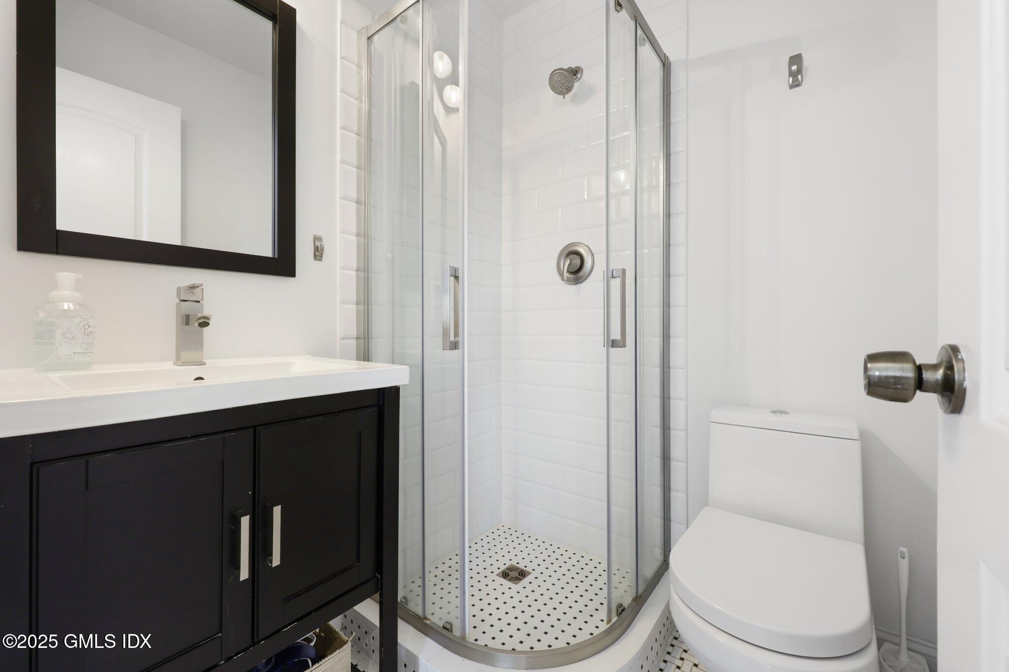 81 Hendrie Avenue Riverside, CT 06878 - Photo 25 of 35 a bathroom with a toilet a sink and shower