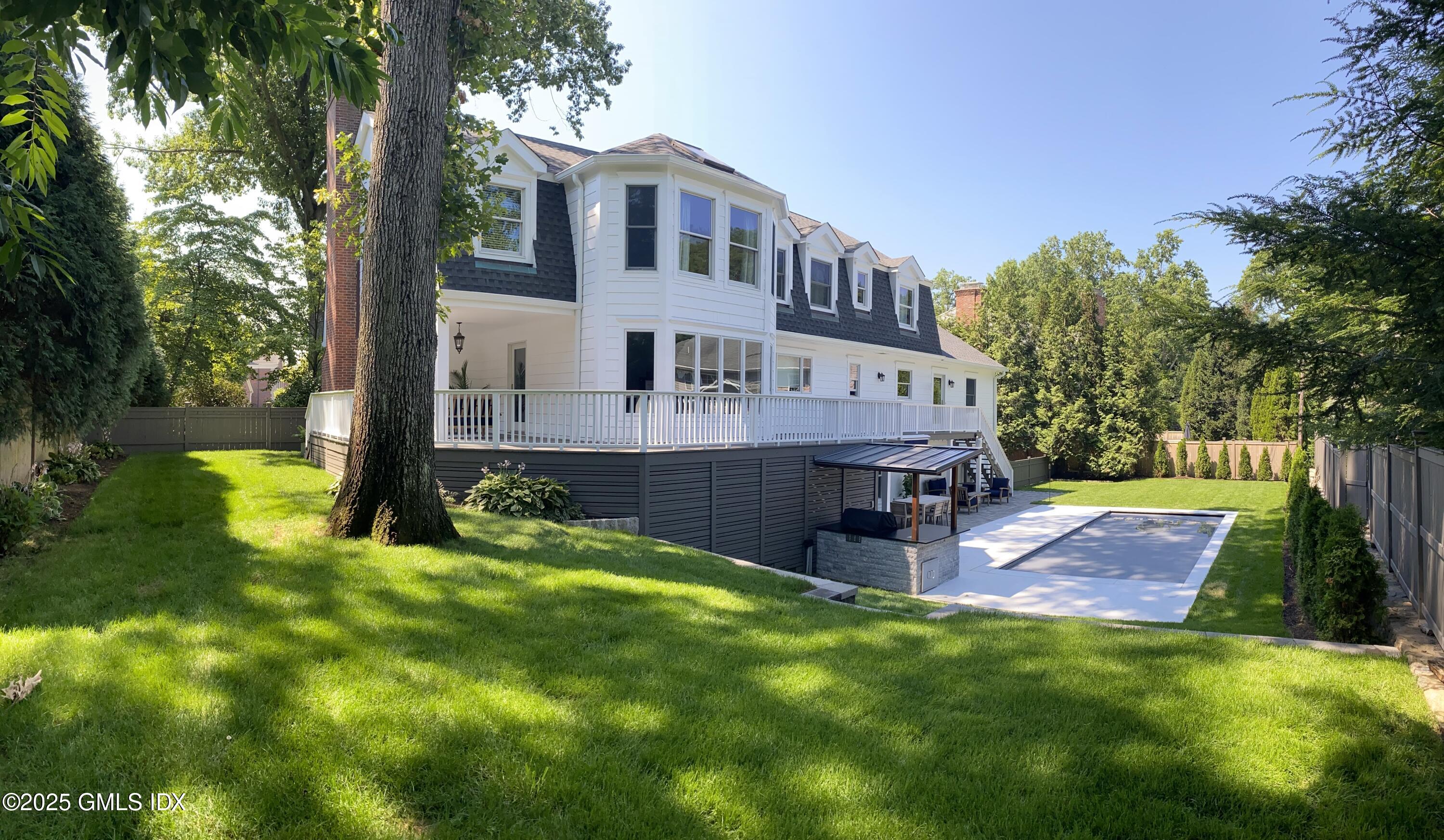 81 Hendrie Avenue Riverside, CT 06878 - Photo 32 of 35 a view of a house with a yard porch and sitting area