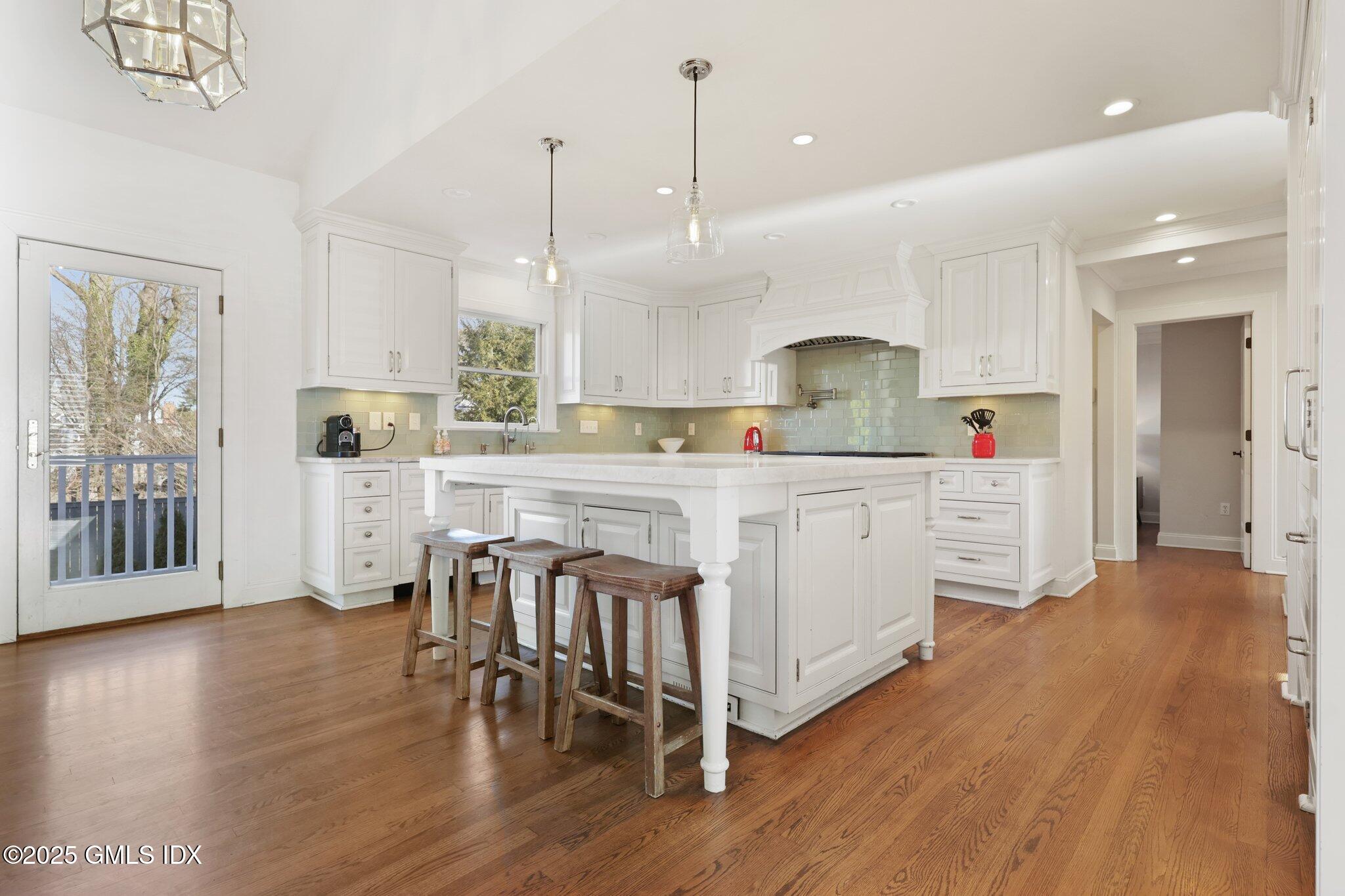 81 Hendrie Avenue Riverside, CT 06878 - Photo 4 of 35 a kitchen with stainless steel appliances a dining table chairs stove and cabinets