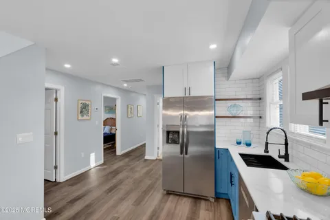 a kitchen with stainless steel appliances granite countertop a sink a stove and a refrigerator