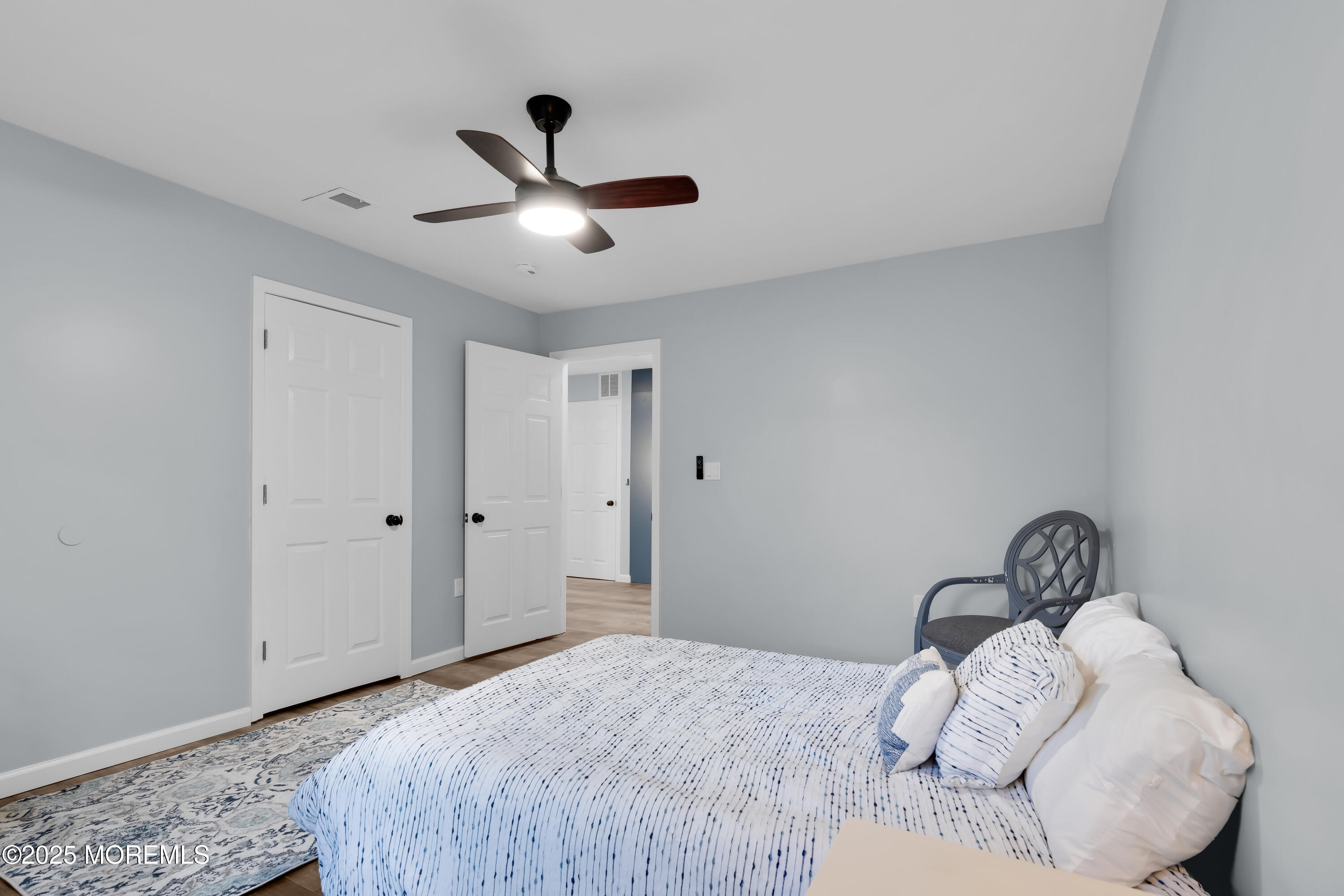 166 Shore Boulevard Keansburg, NJ 07734 - Photo 16 of 36 a bedroom with a bed and a ceiling fan