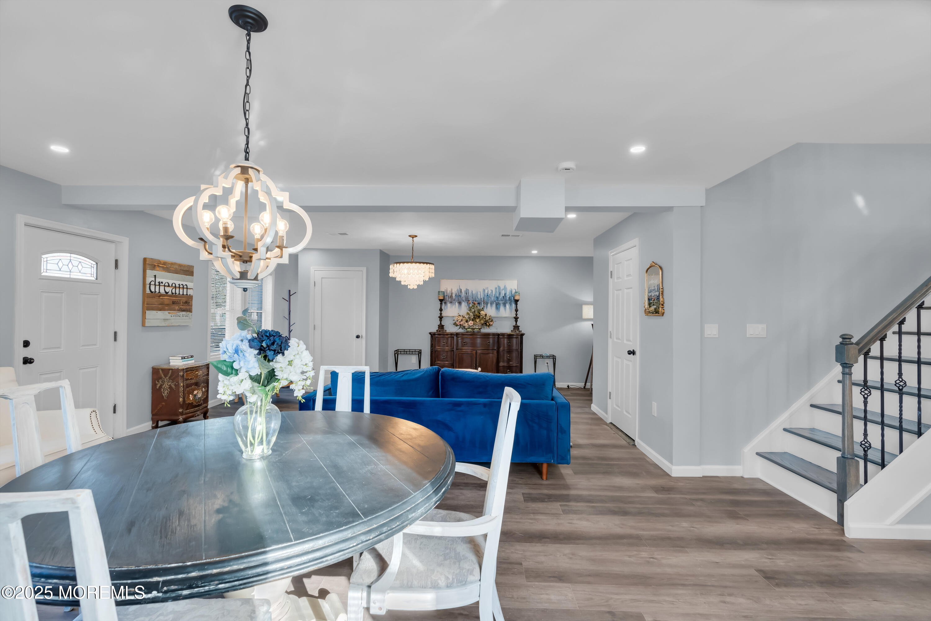 166 Shore Boulevard Keansburg, NJ 07734 - Photo 10 of 36 a dining room with wooden floor a chandelier a wooden table and chairs