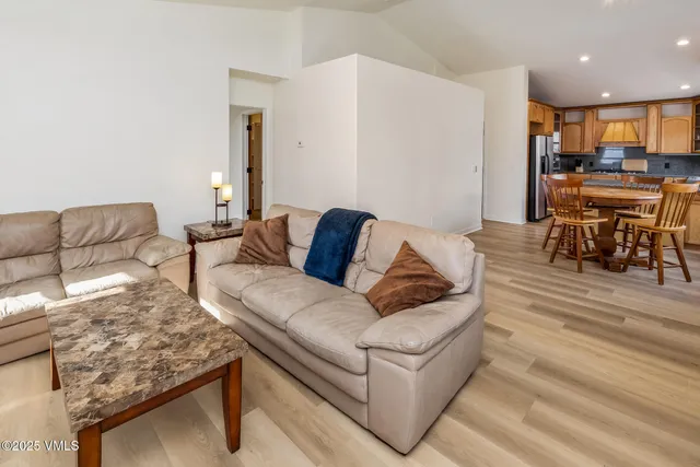 a living room with furniture and kitchen view