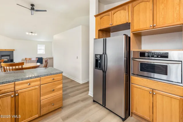 a kitchen with stainless steel appliances granite countertop a refrigerator sink and cabinets