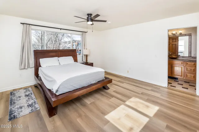 a bedroom with a large bed and a window