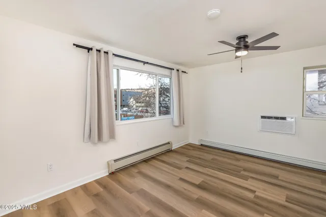 a view of a livingroom with a window and a ceiling fan