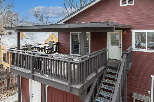 a view of a house with wooden deck