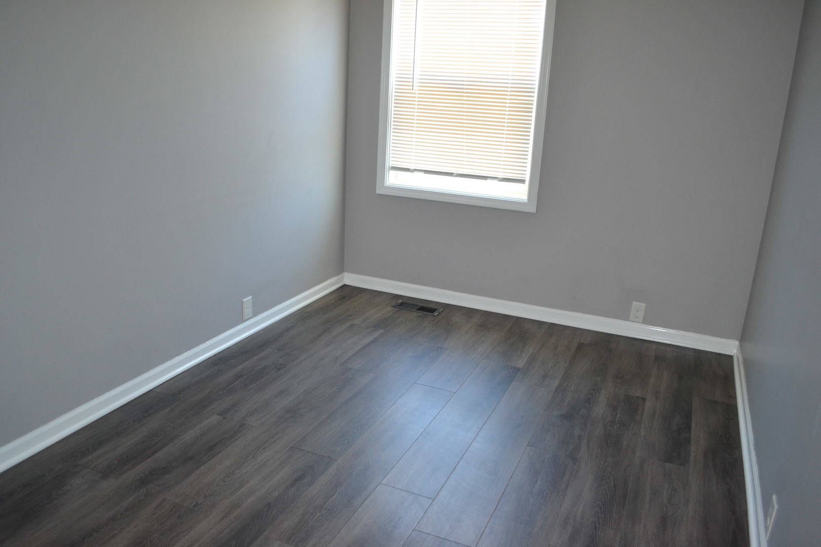307 Karen Avenue Romeoville, IL 60446 - Photo 12 of 20 an empty room with wooden floor and windows