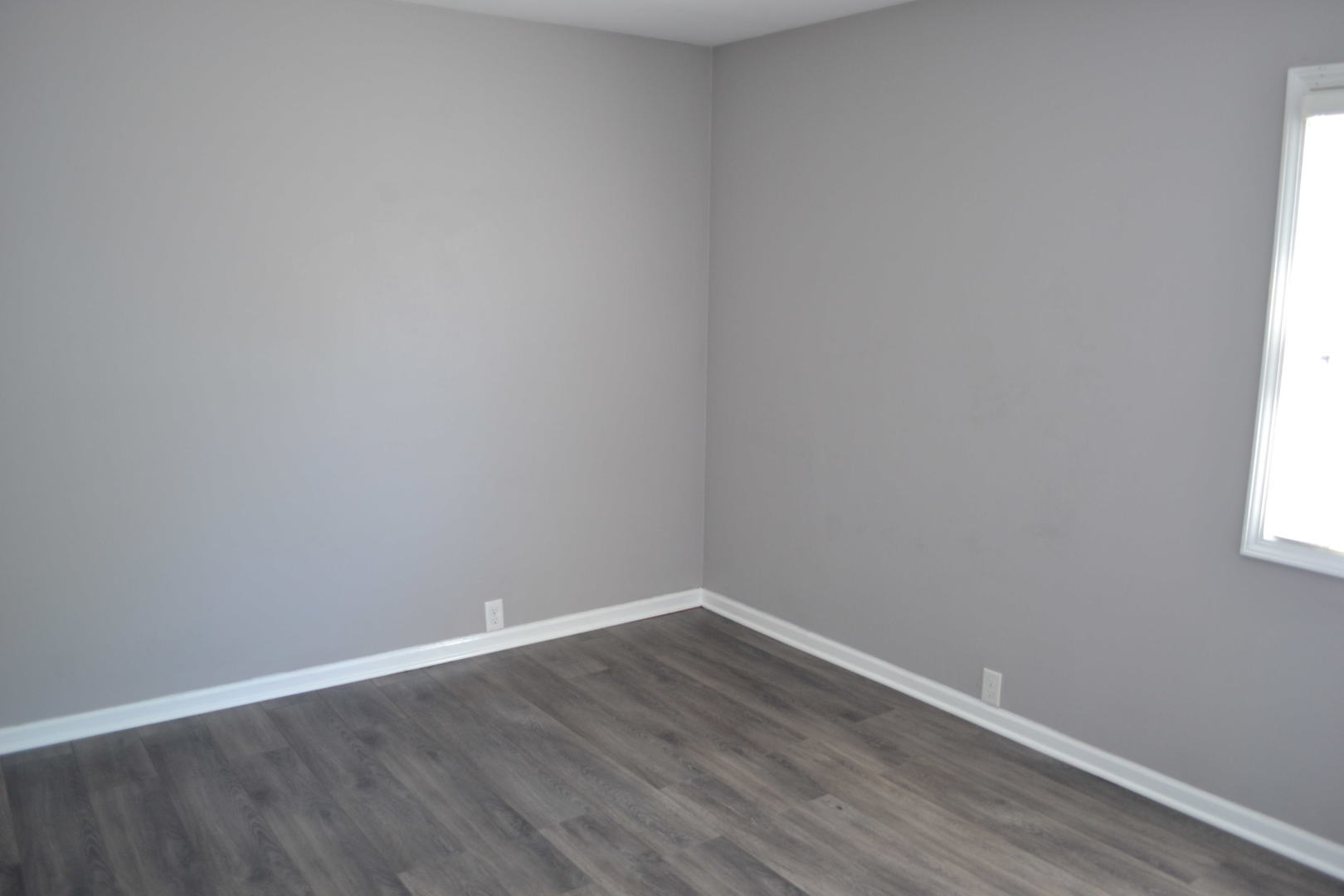307 Karen Avenue Romeoville, IL 60446 - Photo 13 of 20 a view of an empty room with wooden floor and a window