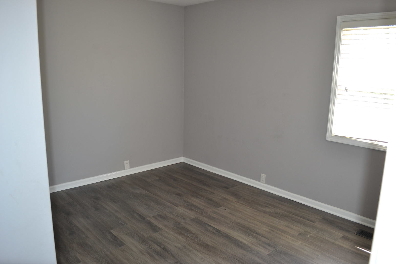 307 Karen Avenue Romeoville, IL 60446 - Photo 14 of 20 a view of an empty room with wooden floor and a window