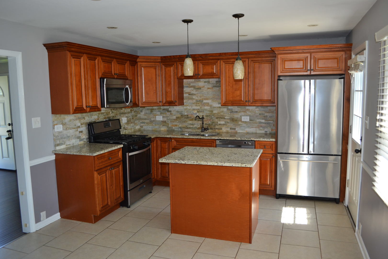 307 Karen Avenue Romeoville, IL 60446 - Photo 4 of 20 a kitchen with stainless steel appliances granite countertop a refrigerator a stove a sink and a microwave