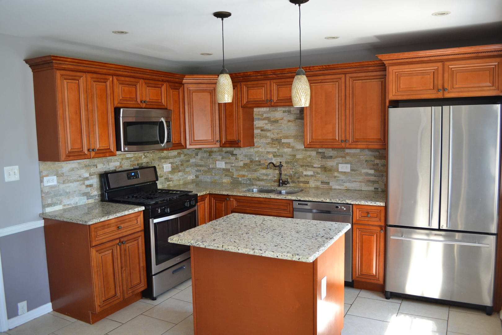 307 Karen Avenue Romeoville, IL 60446 - Photo 5 of 20 a kitchen with stainless steel appliances granite countertop a refrigerator a stove a sink a microwave and wooden cabinets