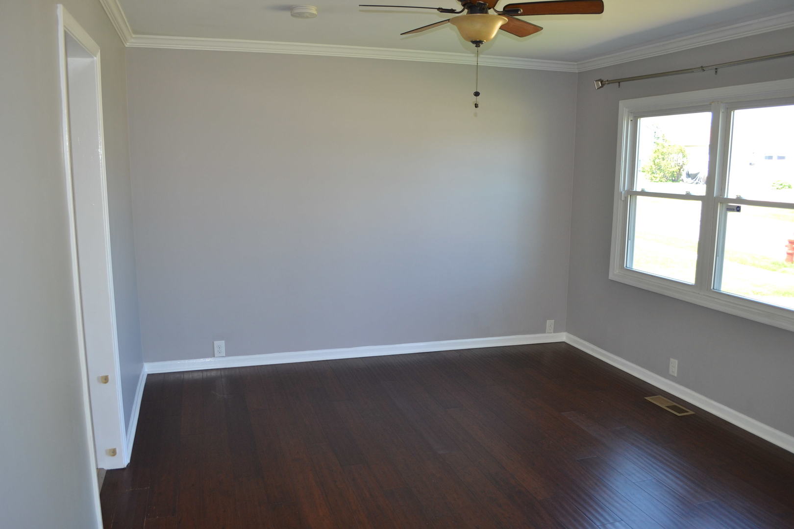 307 Karen Avenue Romeoville, IL 60446 - Photo 8 of 20 an empty room with wooden floor and windows