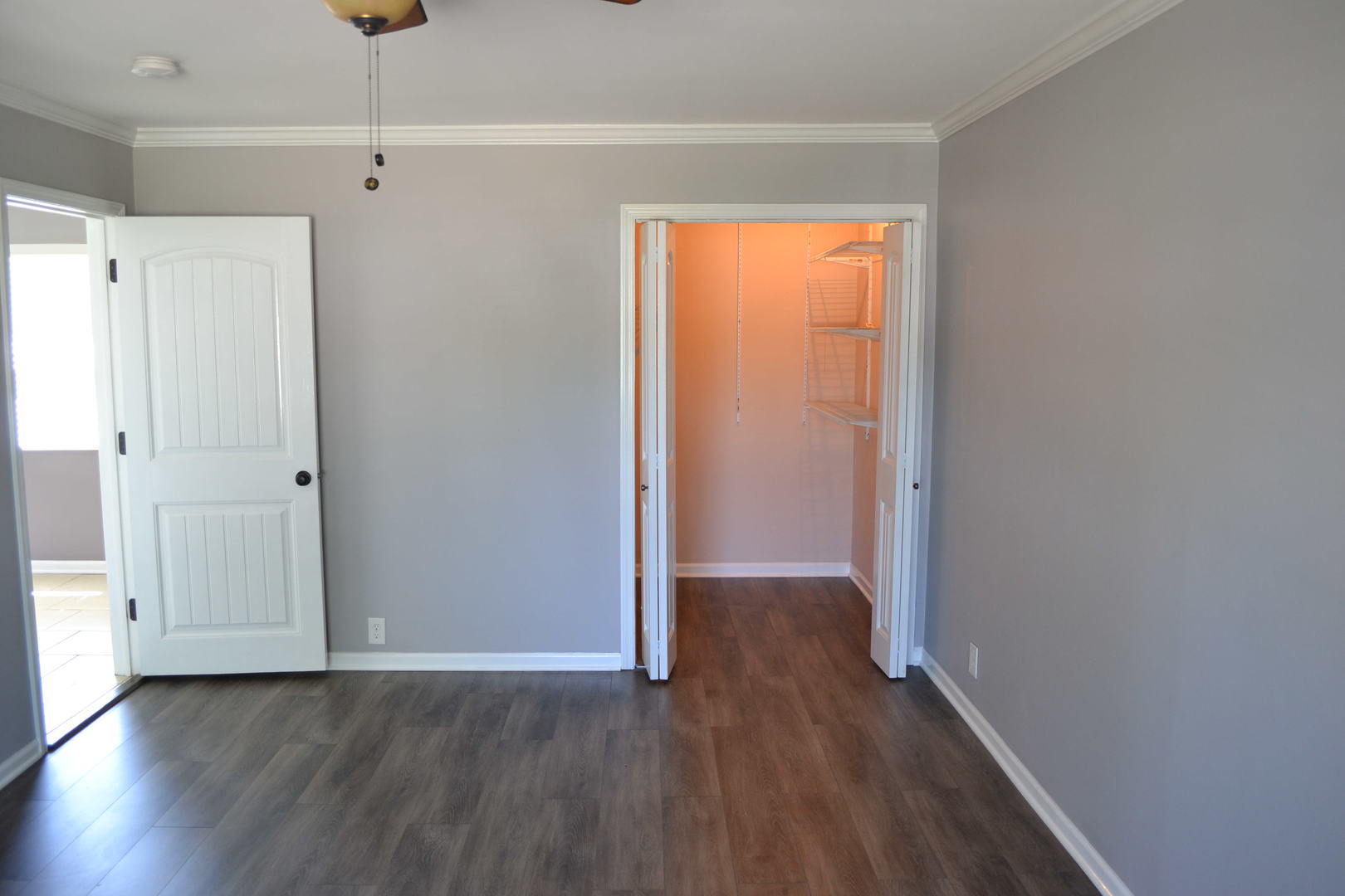 307 Karen Avenue Romeoville, IL 60446 - Photo 10 of 20 a view of an empty room with wooden floor and a window