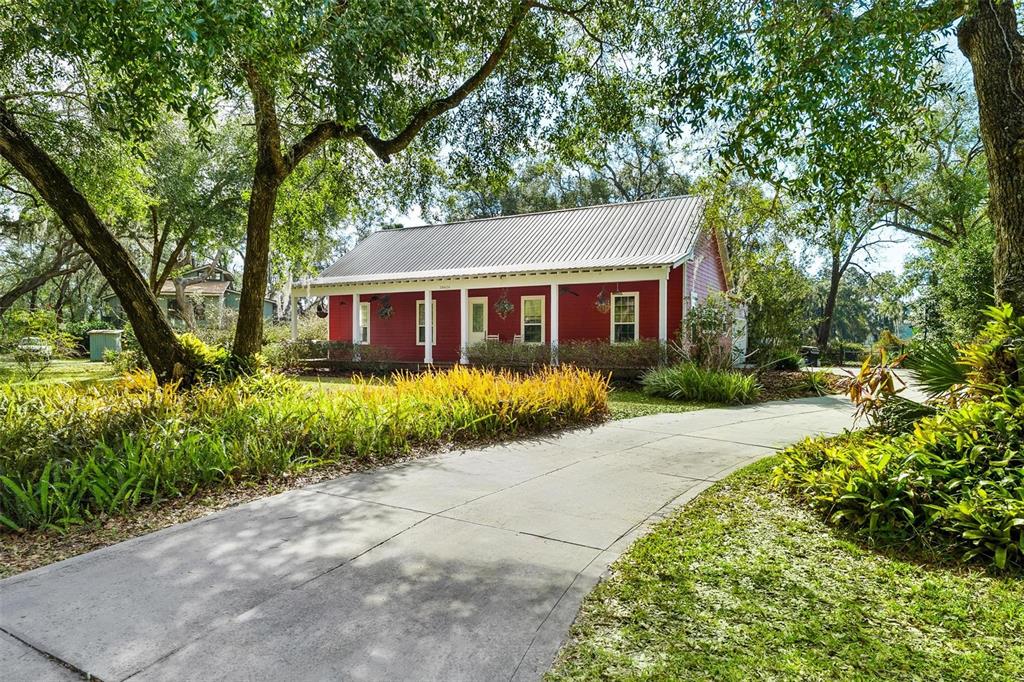 front view of house with a yard and potted plants